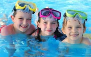 three kids in a pool