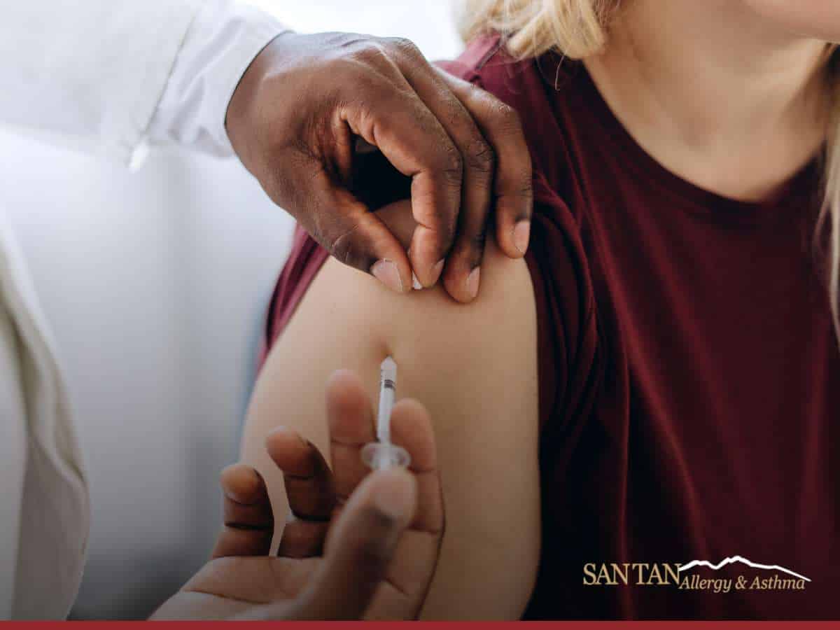 Patient receiving allergy shots in upper arm at clinic